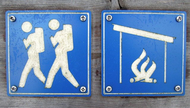 キャンプ場で火の取り扱いに注意を促す標識と安全な焚き火の様子